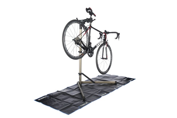 Bike workstands and workbench reviews Photograph of a bike held up in a bike stand on a black matt