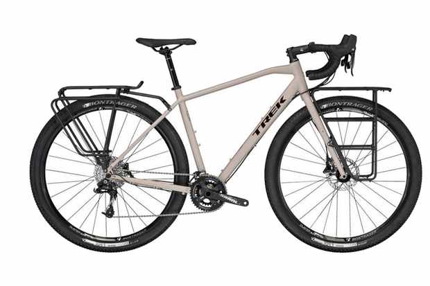 Touring bike reviews Image of a light grey bicycle with front and rear pannier racks